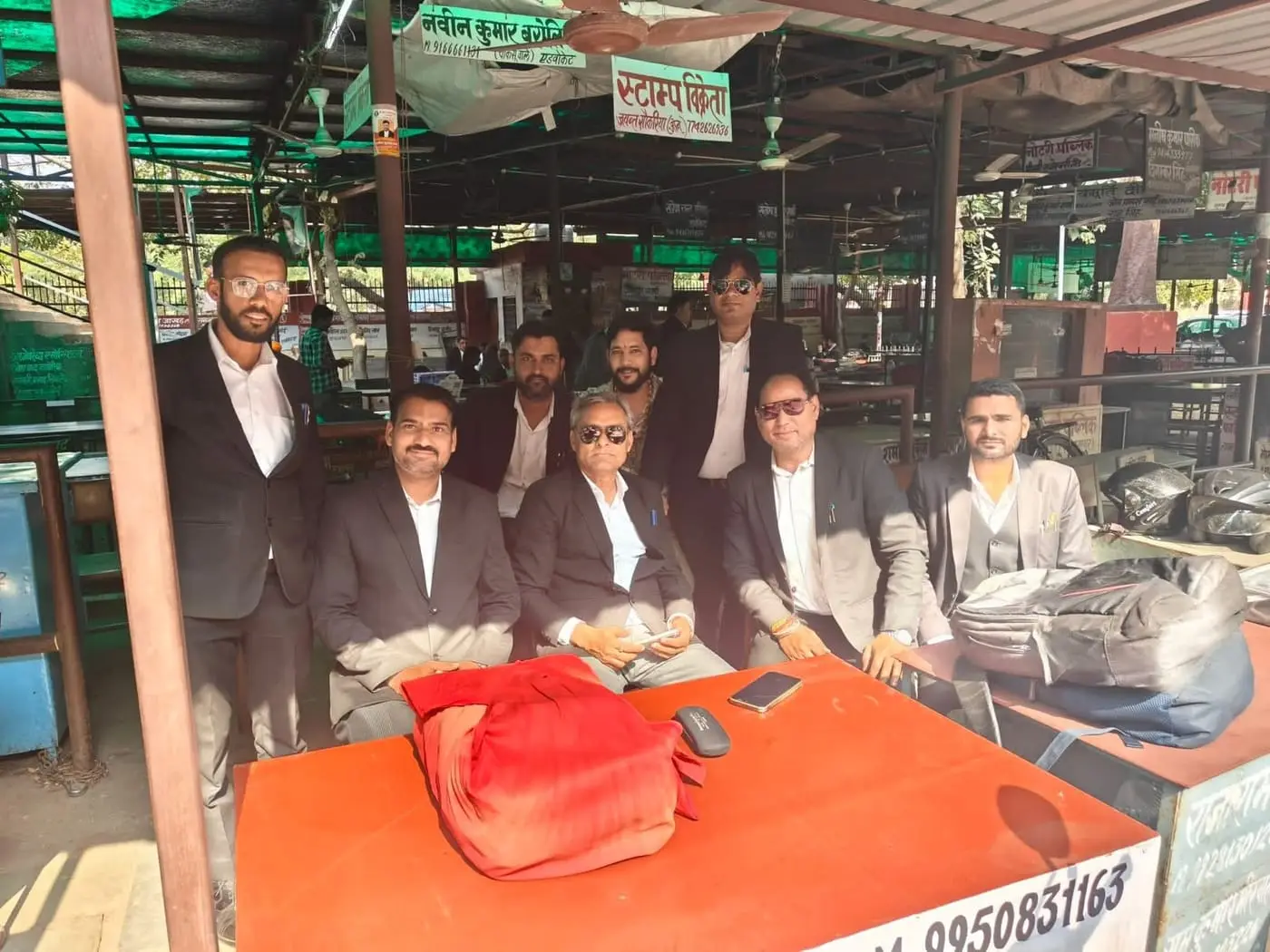 Advocates in robes seated together at the open-air chambers at the court in Jaipur