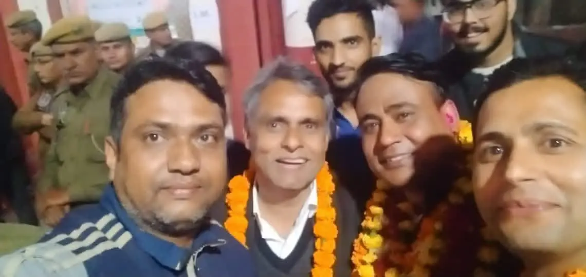 Garlanded men photographed together in a crowd